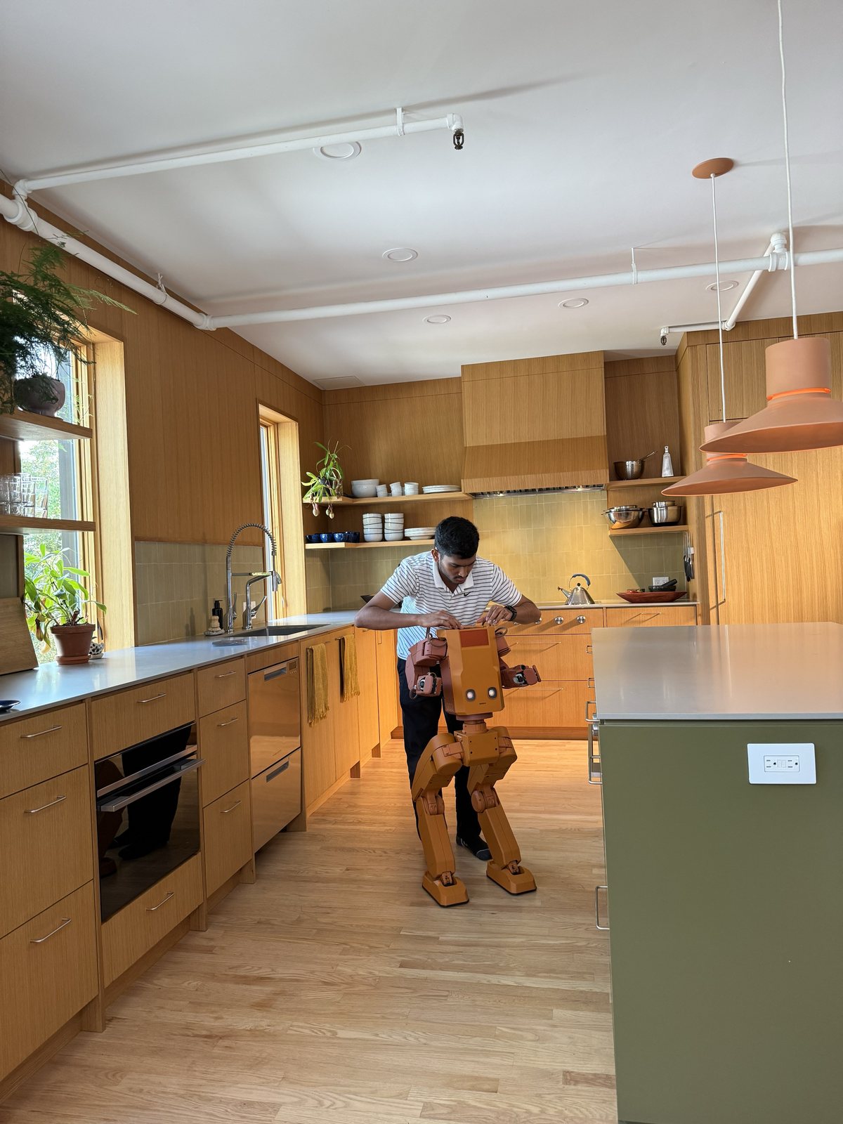 Sankalp working on Voxel's head in a home kitchen